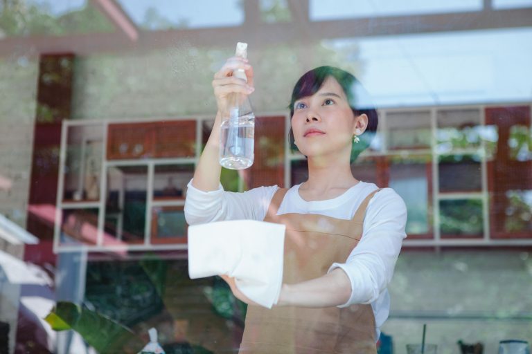 asian helper cleaning glass