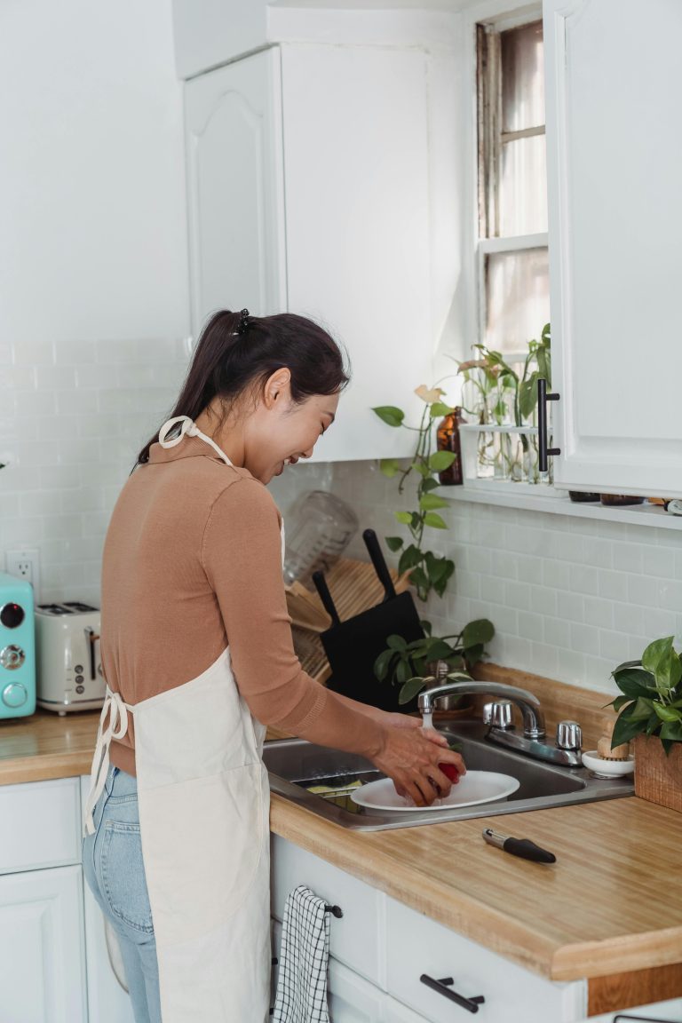 Asian woman cleaning dishes